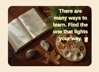 book and leaf and paint tray on table with a quote there are many ways to learn find the one that lights your way with a candle